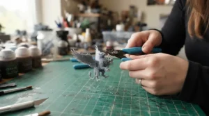 Post-processing workflow for a resin vs FDM 3D printer for miniatures project on a cutting mat.